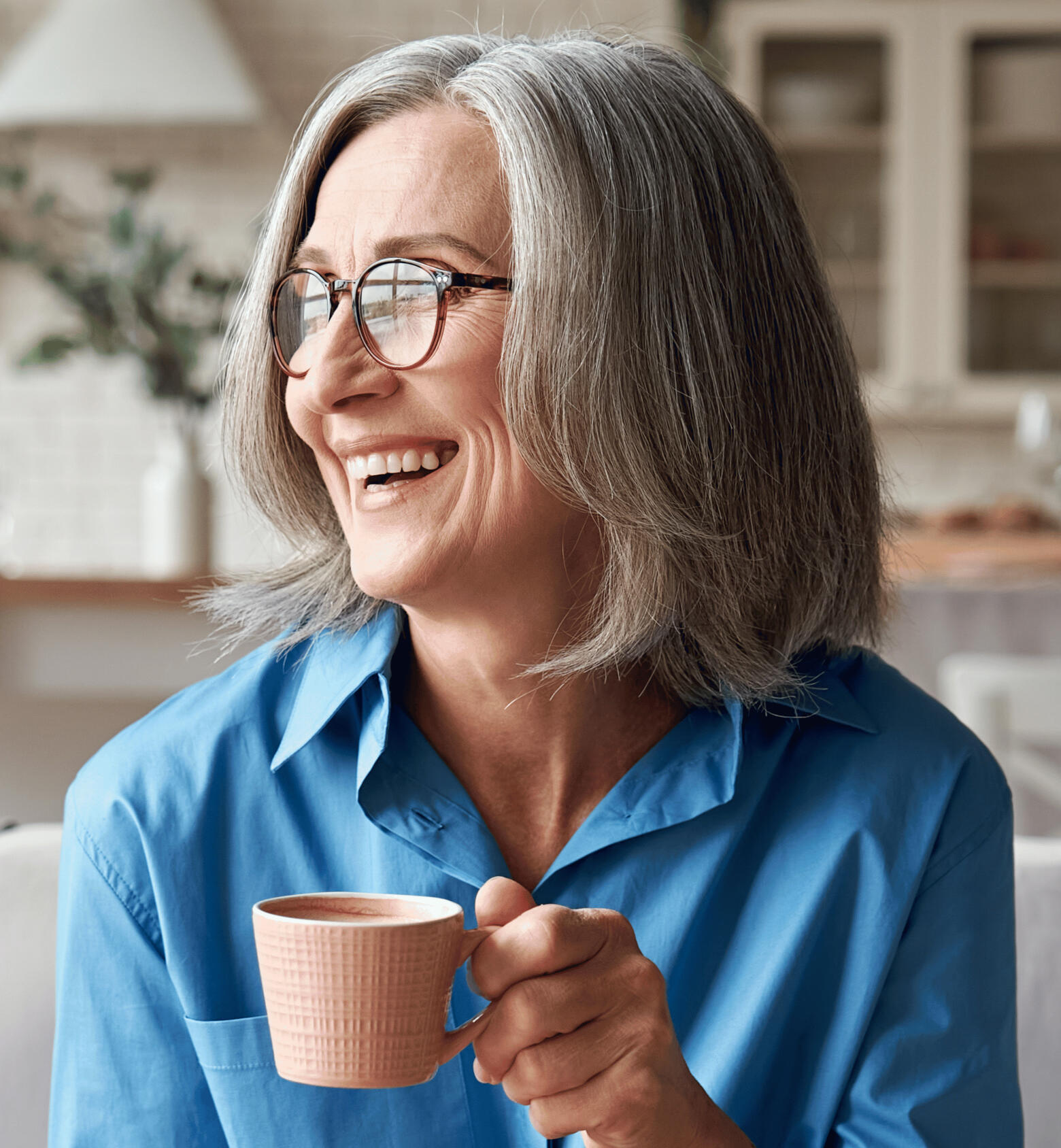Woman smiling with a cup of tea